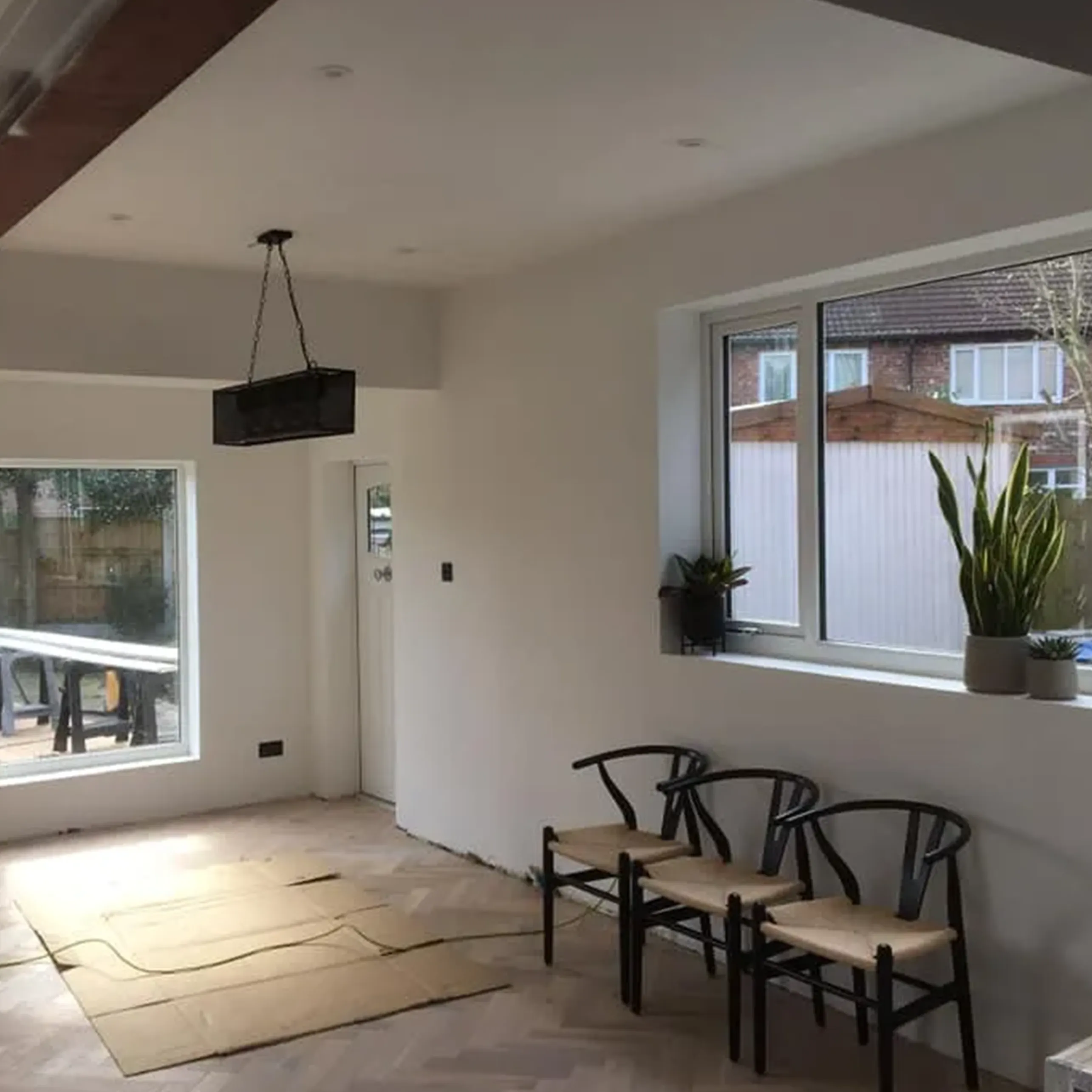 A room with three chairs and a window.