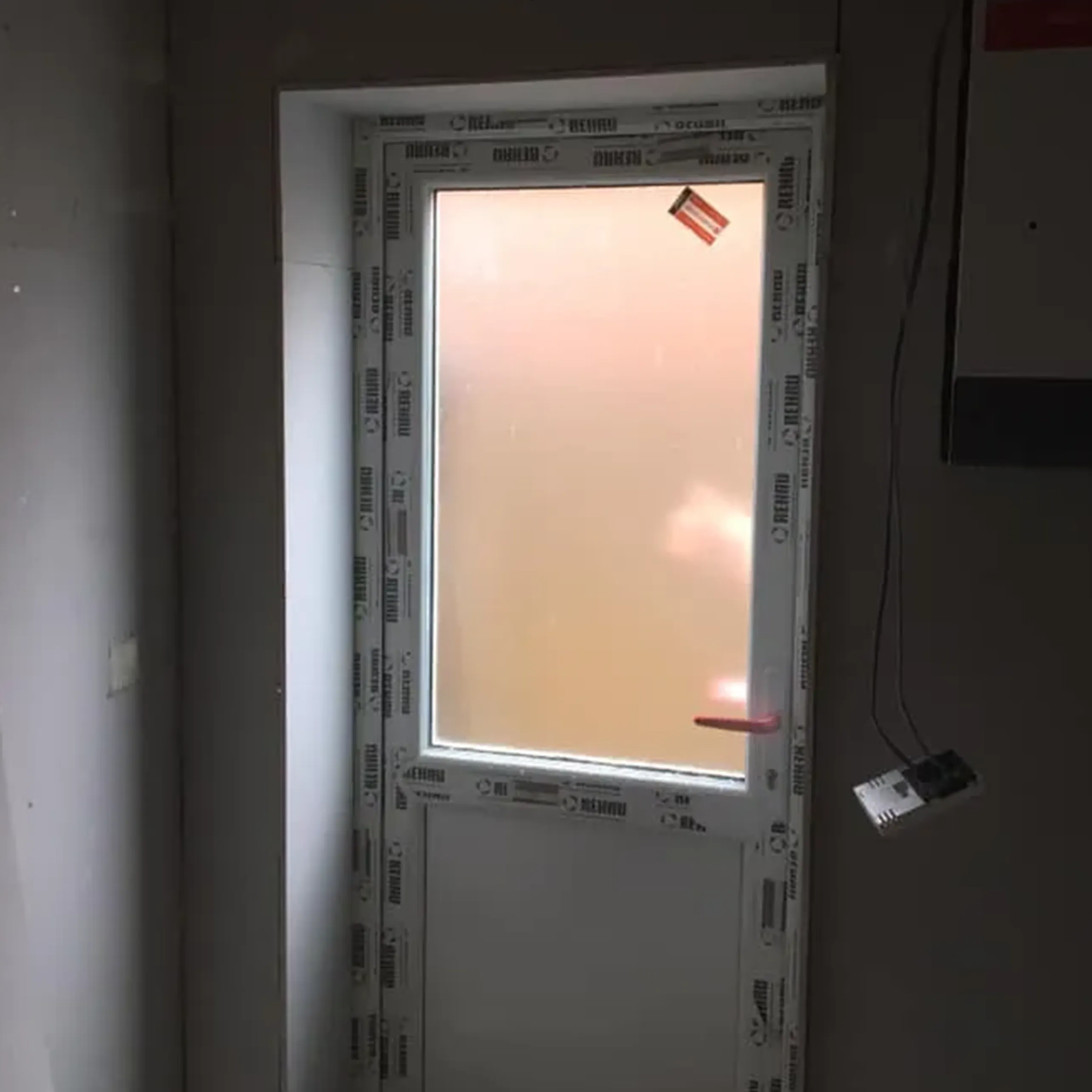 A white door with a small window in it.