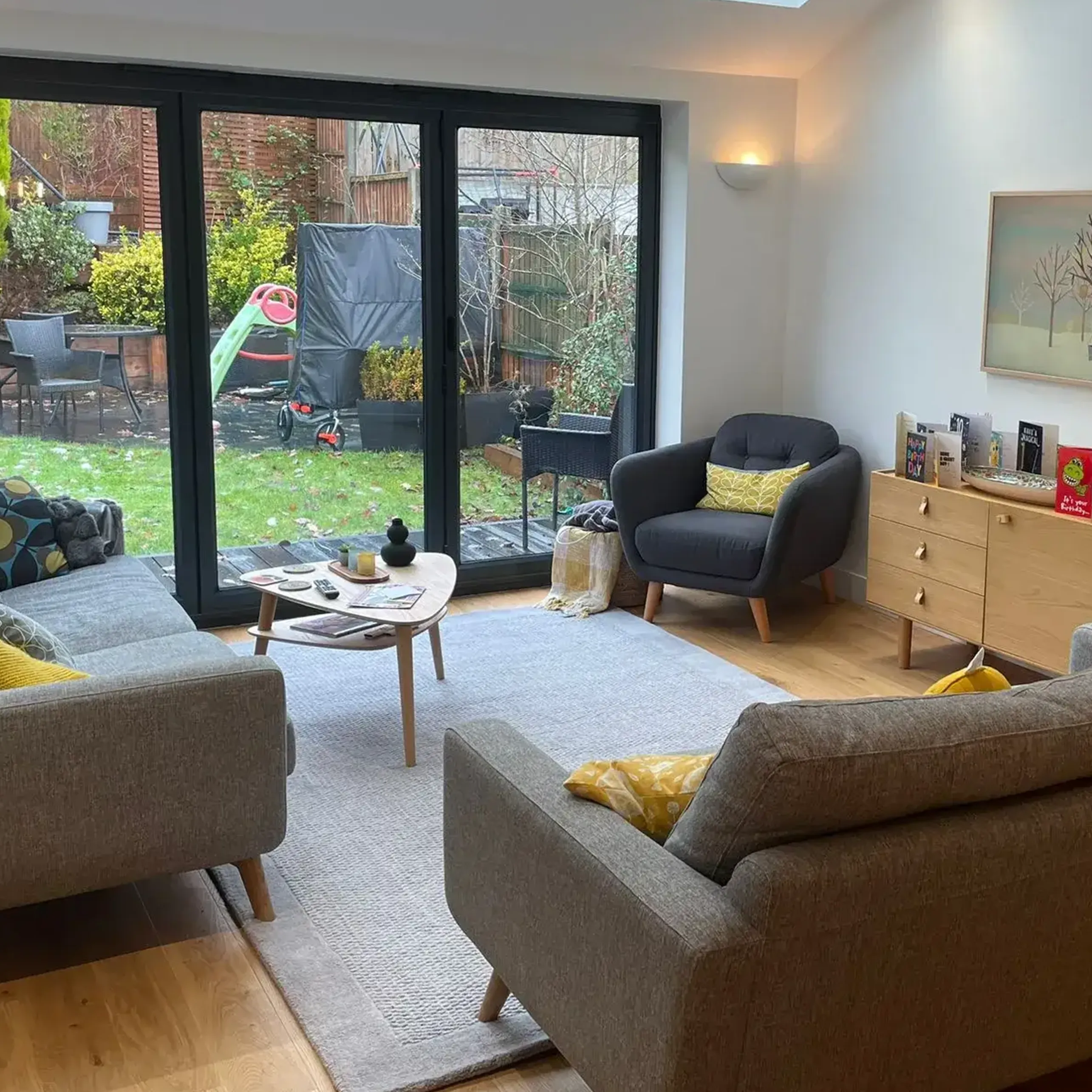 A living room filled with furniture and a sliding glass door.