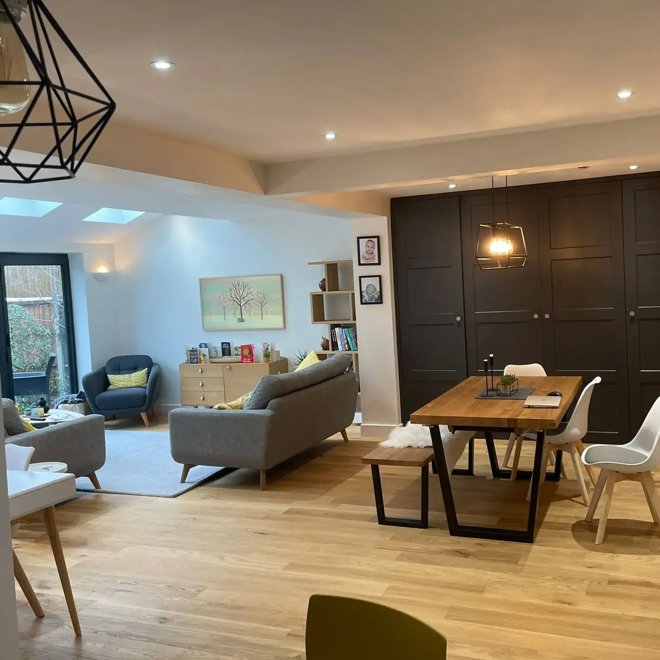 A living room filled with furniture and a wooden table.