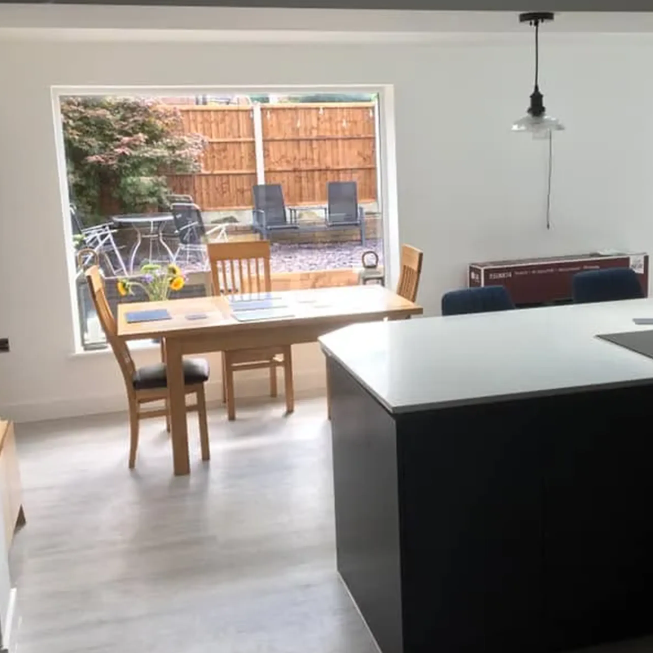A kitchen with a table, chairs and a window.