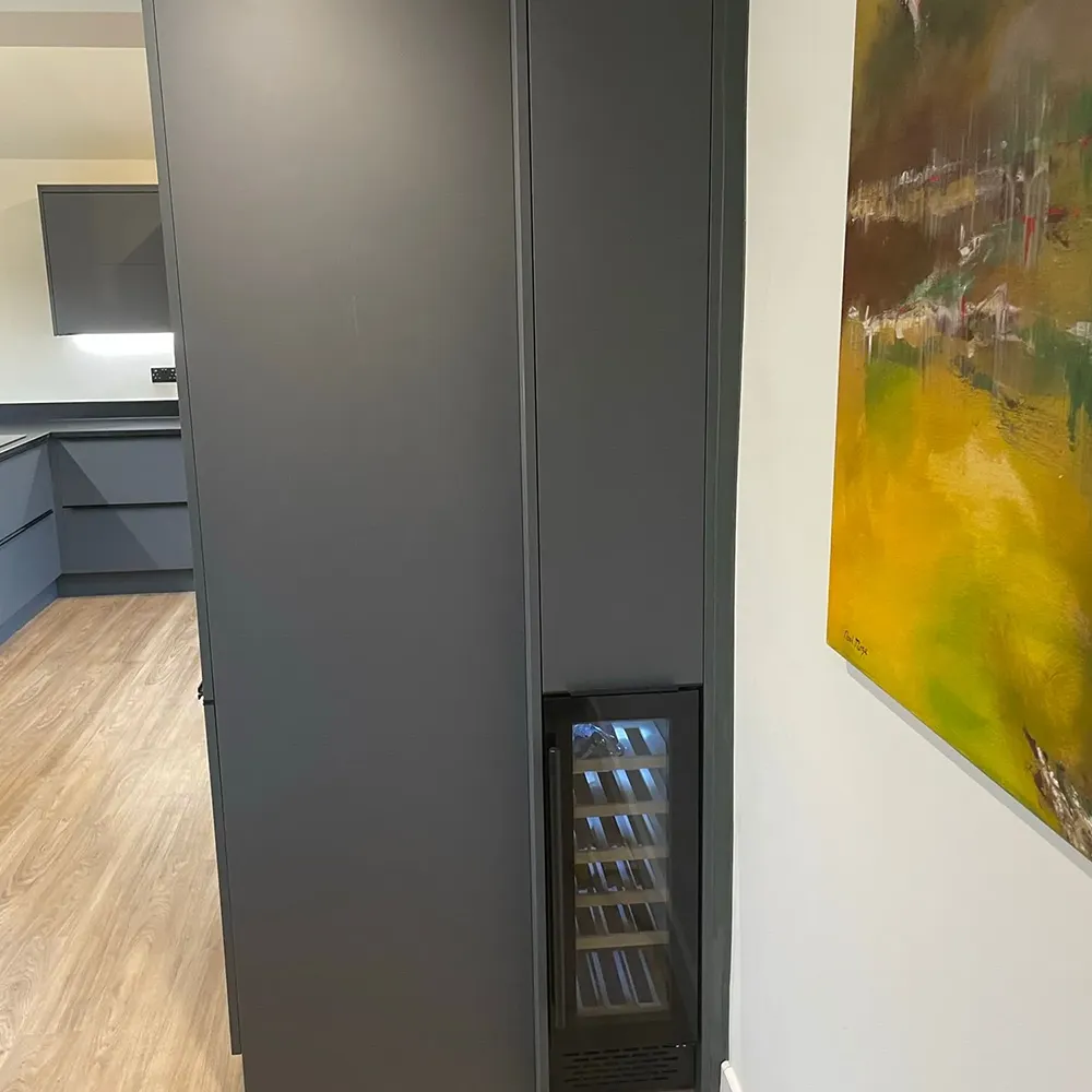 a refrigerator with a door open in a kitchen