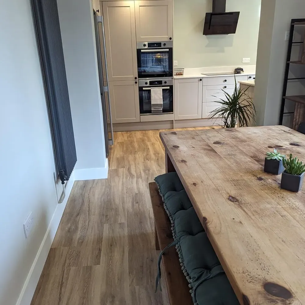 a kitchen with a wooden table and oven