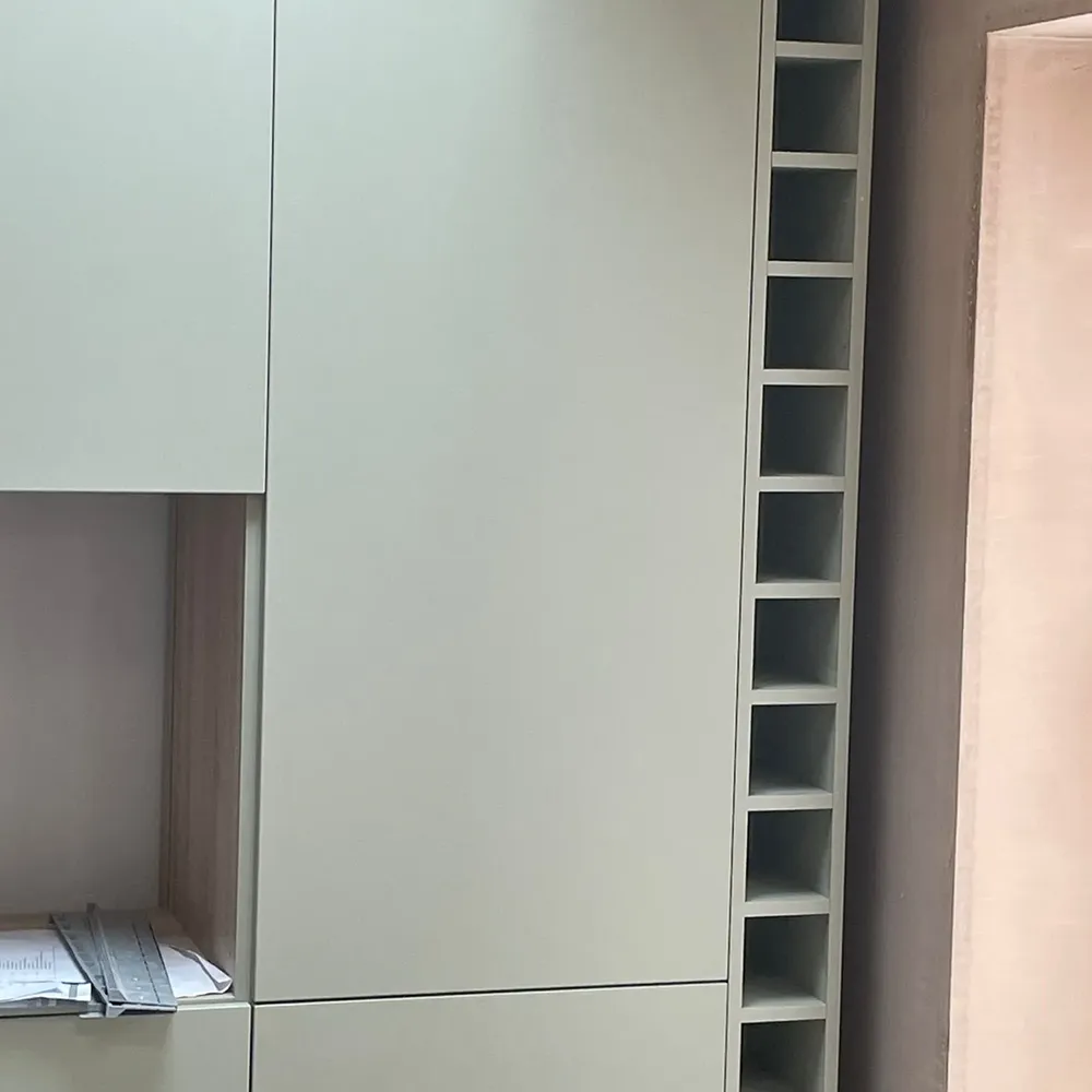 a white cabinet with a book shelf in the middle of it