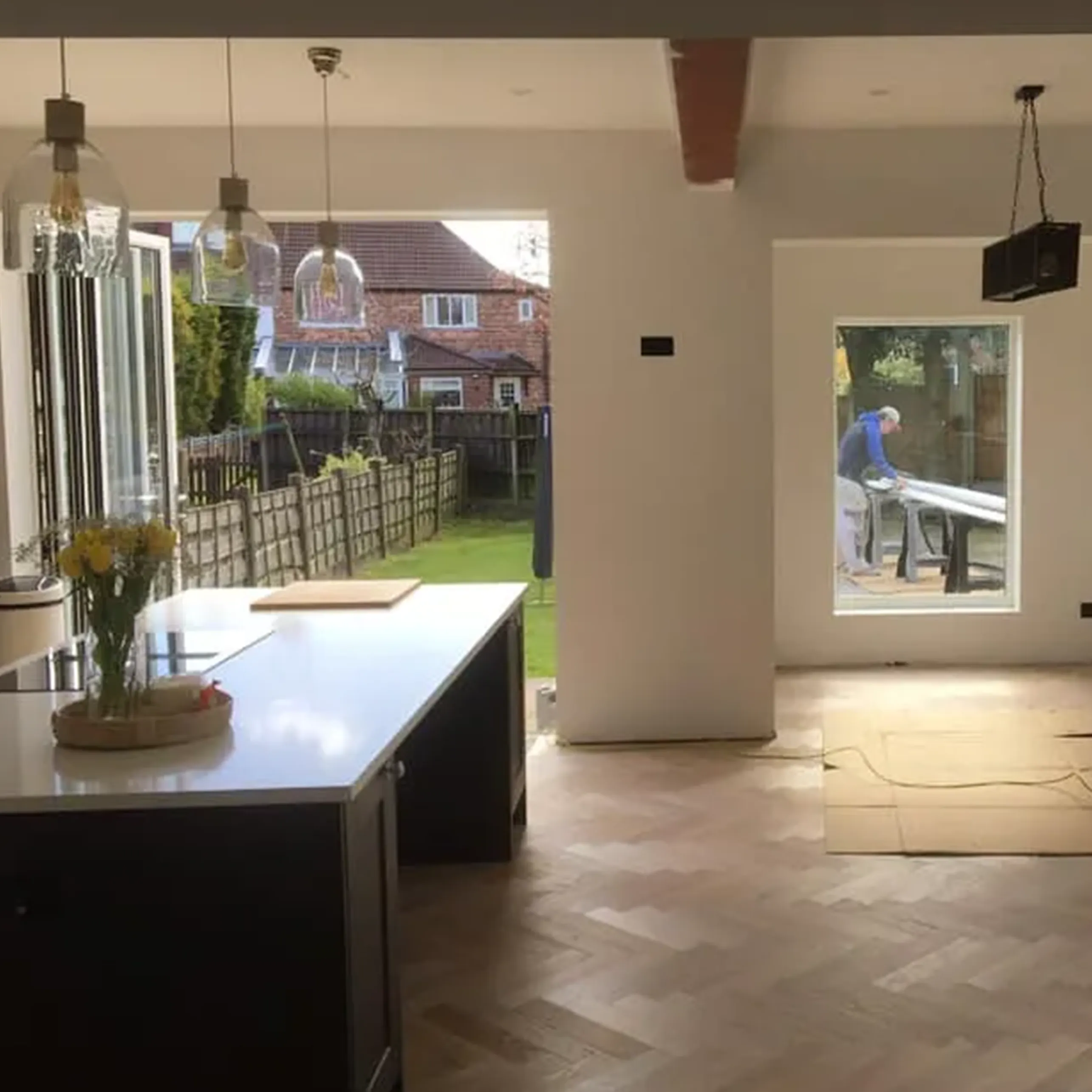 A kitchen with a large island and a large window.
