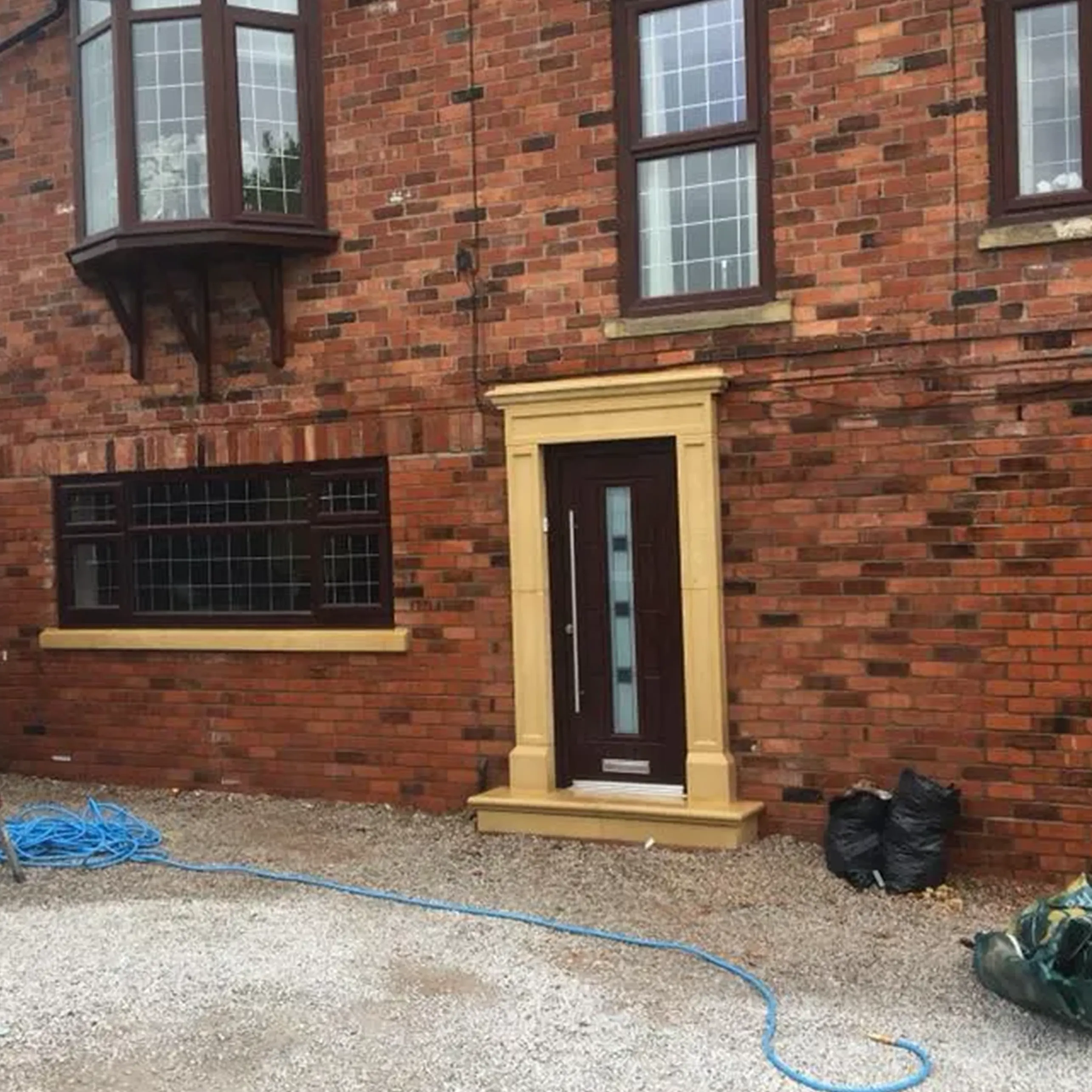 A red brick building with a door and window.