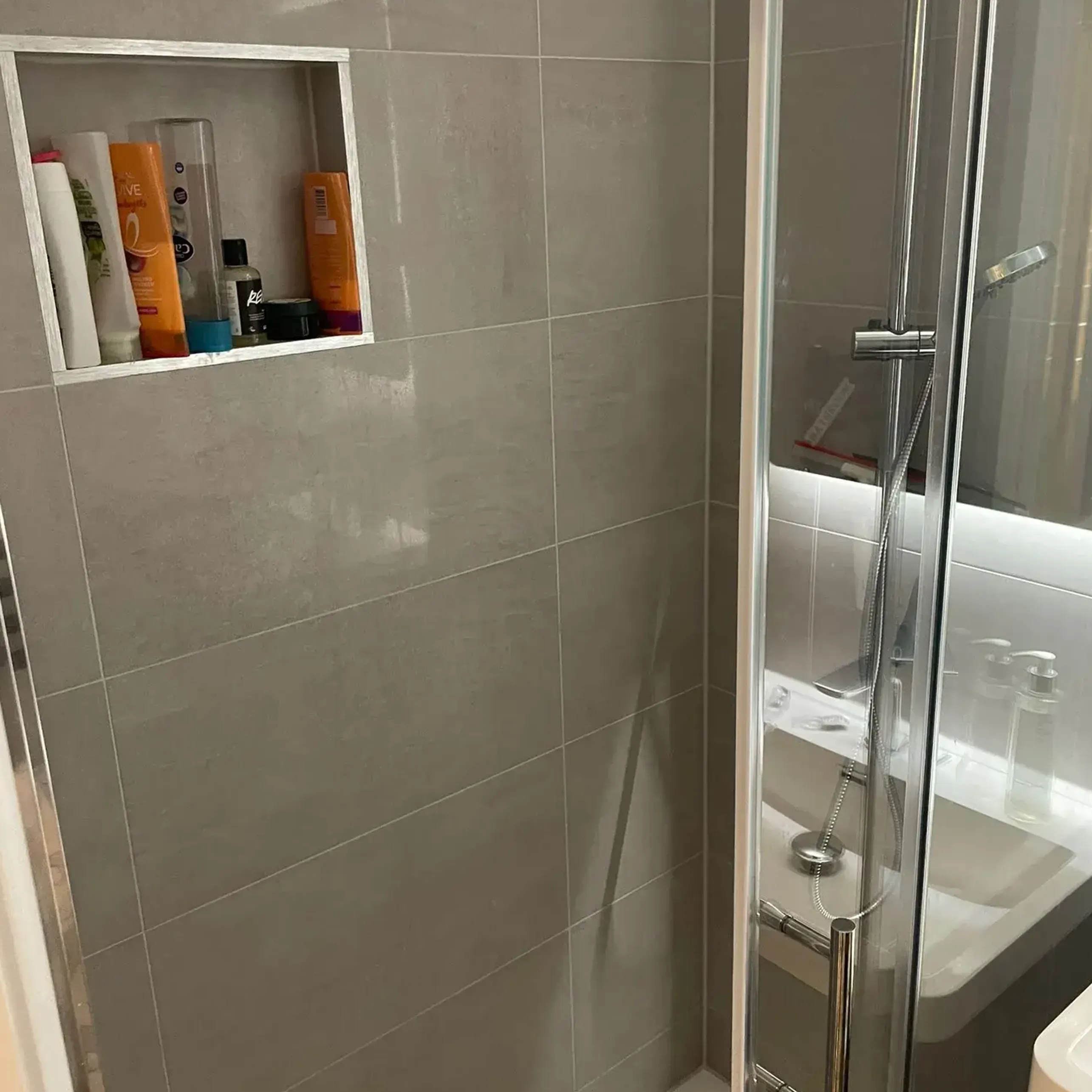 A bathroom with a shower, toilet and sink.